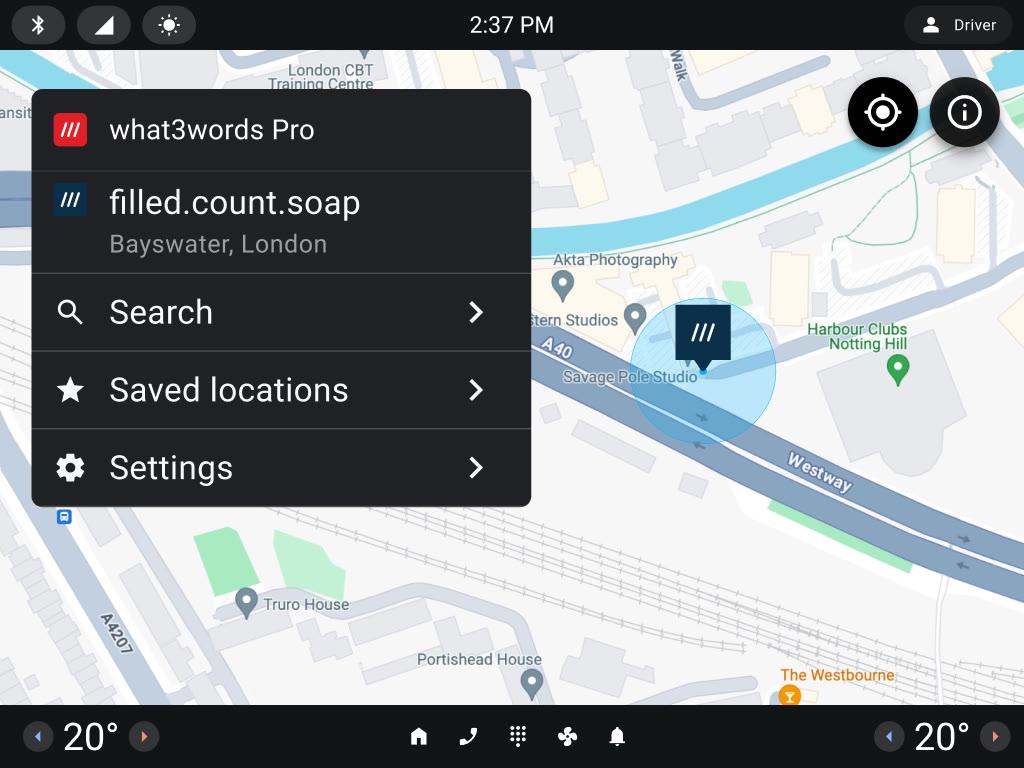 what3words Pro on an Android Automotive head unit, showing a three-word address on the map with search, saved locations and settings